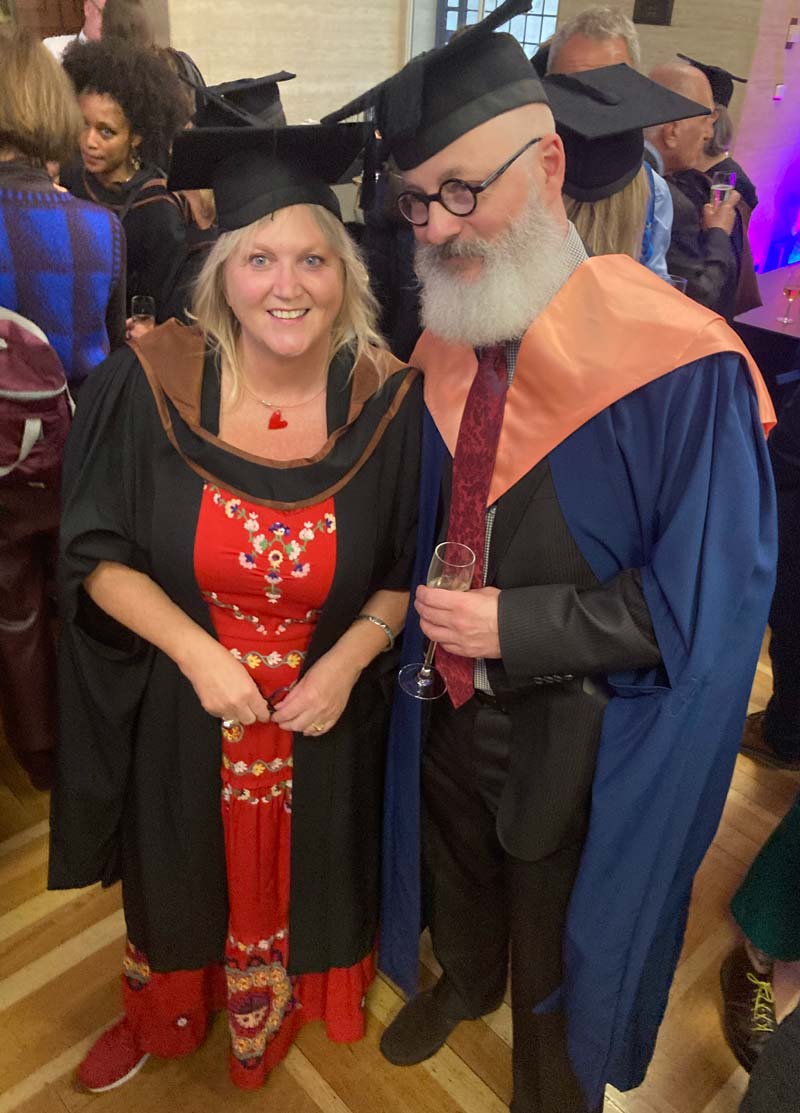 A picture of Karen Constantine and Toby Litt in graduation outfits.