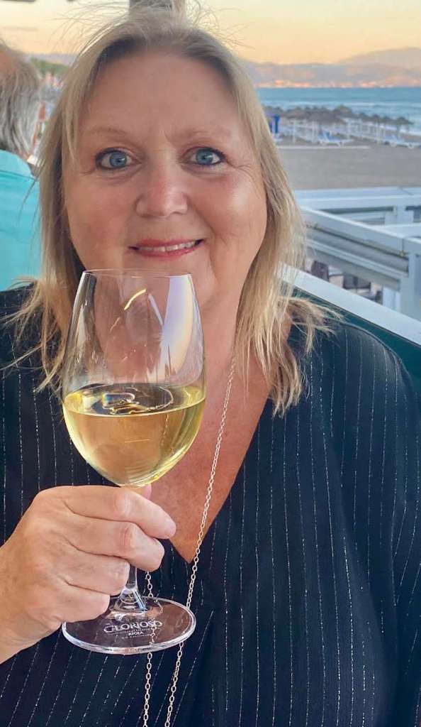 Karen Constantine with a glass of wine